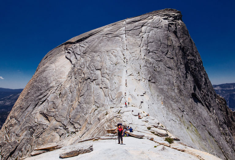 A hiker coming down the cables on Yosemite's Half Dome