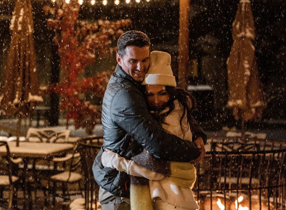 Couple embracing in snow