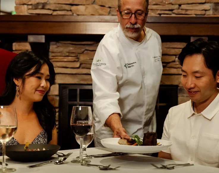 A couple being served at Embers Restaurant at Tenaya at Yosemite