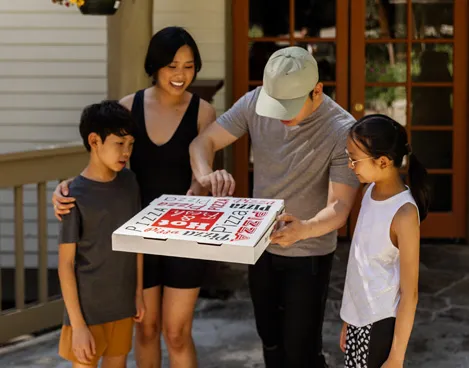A family getting a pizza from Timberloft Pizzeria at Tenaya at Yosemite