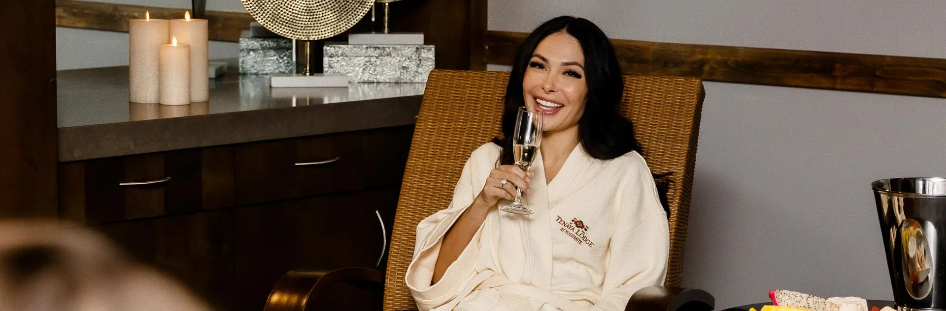 A woman enjoying a glass of champagne at Tenaya's Ascent Spa