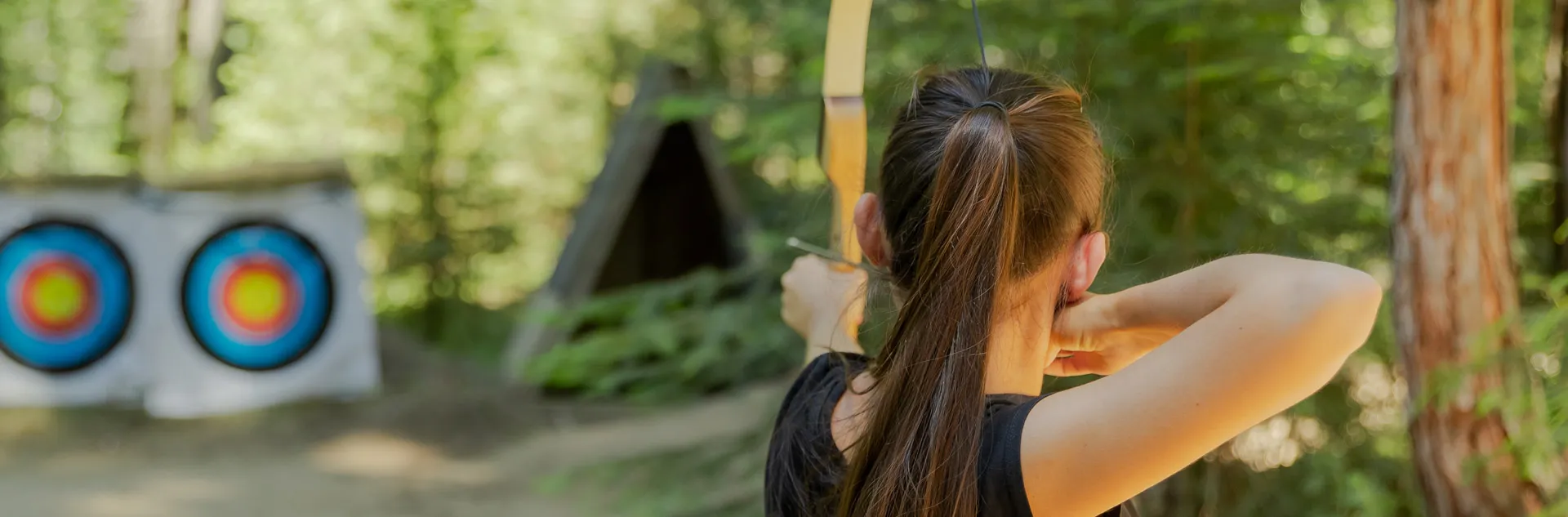 A Tenaya guest practicing their archery