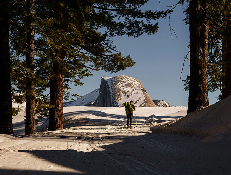 Winter in the Sierras 2 A winter visitor in Yosemite National Park taking in a view of Half Dome