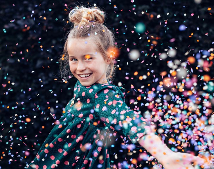 New Year's Eve Bash for Kids 3 A girl throwing a handful of confetti