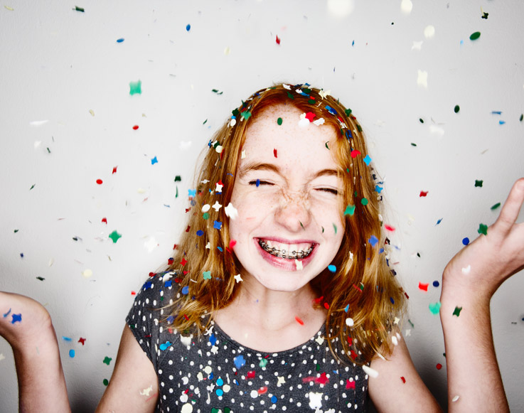 New Year's Eve Bash for Kids 2 A happy girl under a cloud of confetti