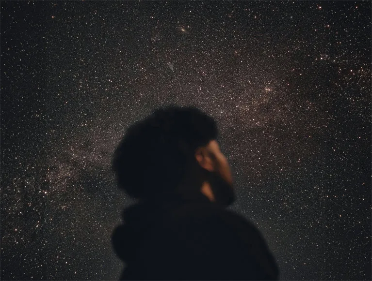 Itineraries 2 A Tenaya visitor looking up at a starry night sky