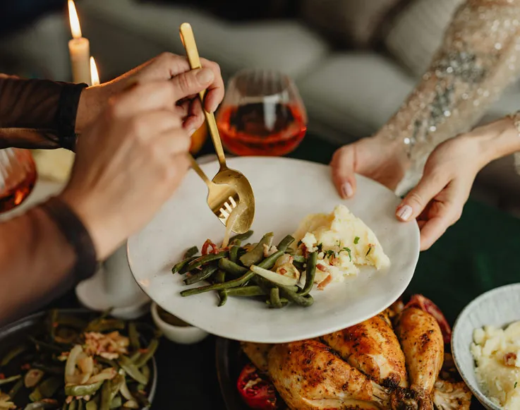 Guests preparing a plate for Thanksgiving