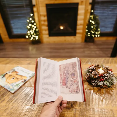 Winter Wonderland Cabins 4 A guest reading a book in a holiday cabin at Tenaya at Yosemite