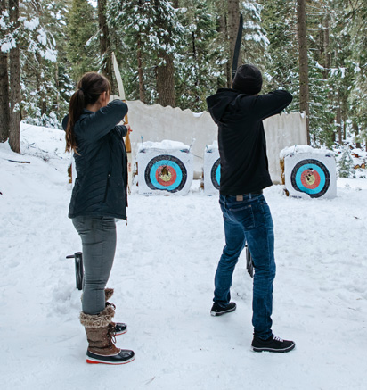 Tenaya at Yosemite guests practicing archery in winter