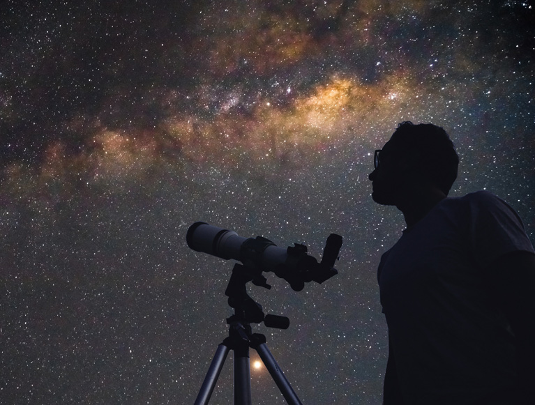 Telescope viewing under a starry night sky