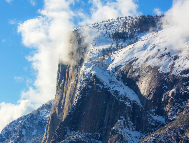 Clouds over the top of a rock formation in Yosemite Valley