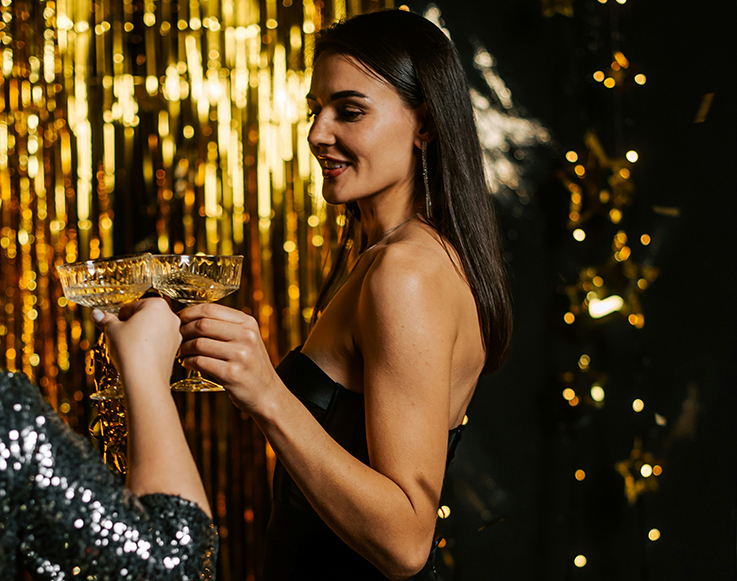 Two guests toasting champagne glasses on New Year's Eve