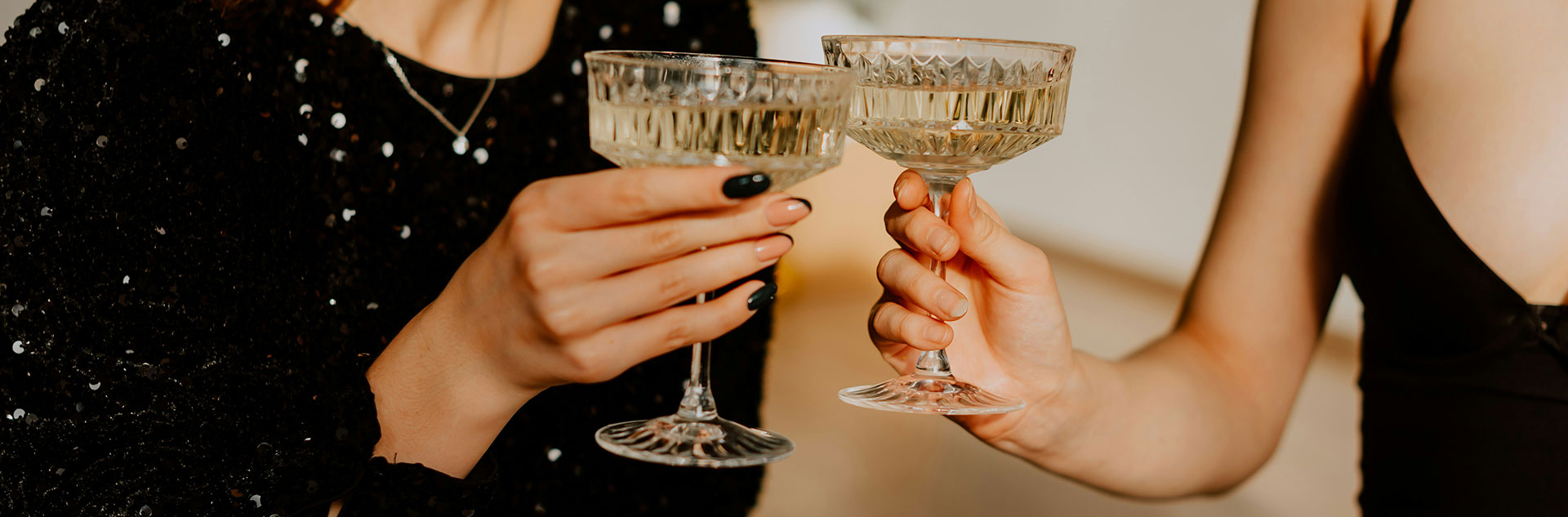 Two guests toasting champagne glasses on New Year's Eve
