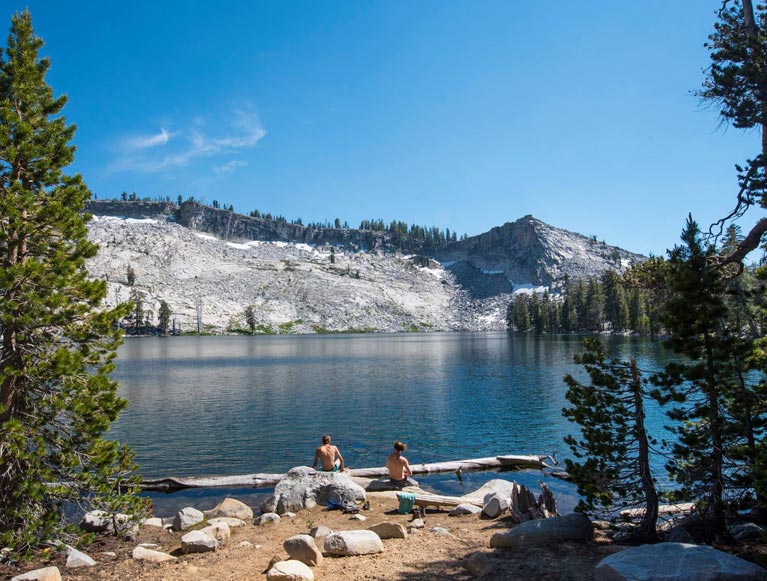 Two hikers at Ostrander Lake in Yosemite National Park