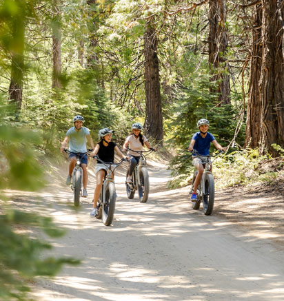 A family riding e-bikes near Tenaya at Yosemite