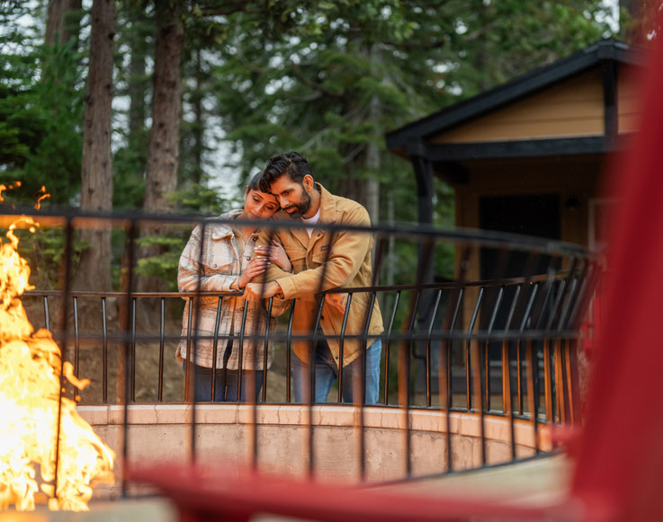A couple enjoying the outdoor fire pits at the Explorer Cabins at Yosemite