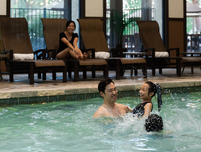 A family swimming in the indoor pool at Tenaya at Yosemite