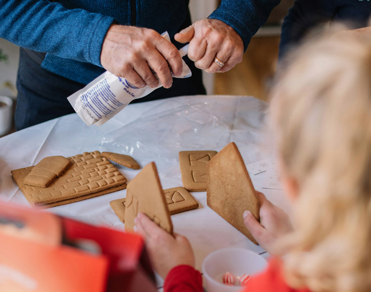 A family building a gingerbread house at Tenaya at Yosemite