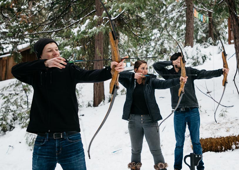 Tenaya at Yosemite guests practicing archery in winter