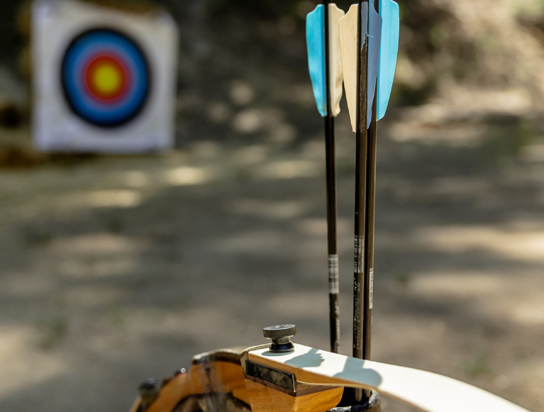 A bow and arrow with an archery target
