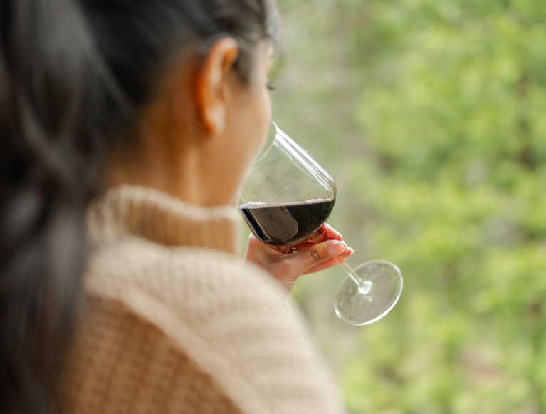 A guest drinking a glass of wine at Tenaya at Yosemite
