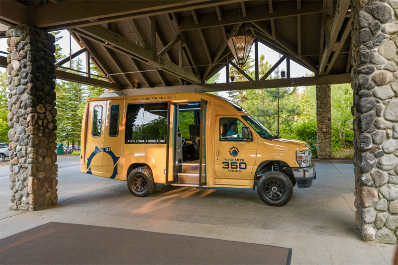 A Yosemite 360 Tours bus parked outside of Tenaya at Yosemite