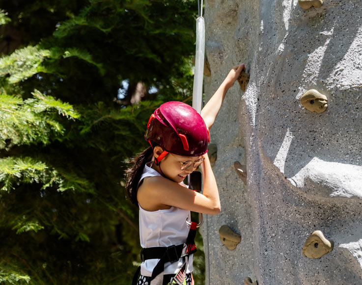 A child on the climbing wall at Tenaya at Yosemite