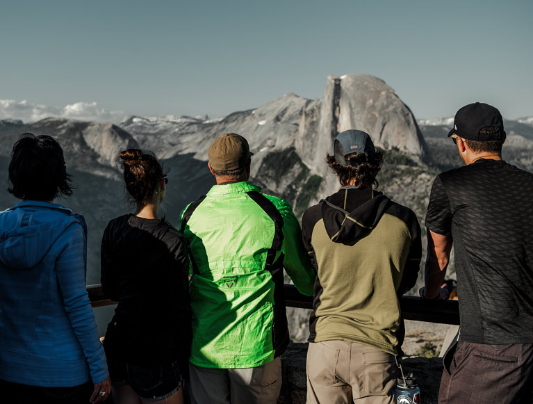 A group of Yosemite visitors looking at Half Dome