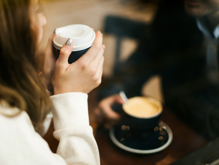 A guest enjoying a hot beverage at Tenaya at Yosemite
