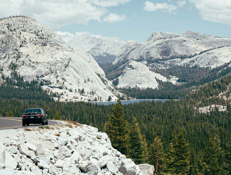 A car on the road to Tuolumne Meadows in Yosemite National Park