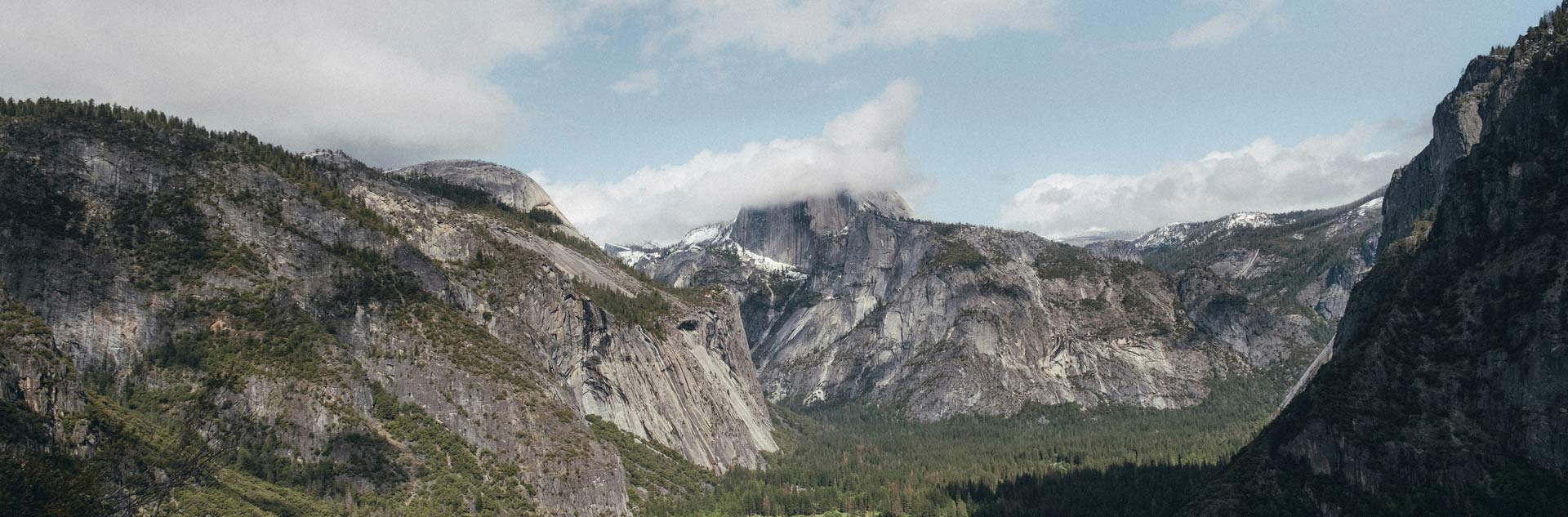 Half Dome obscured by clouds in Yosemite Valley