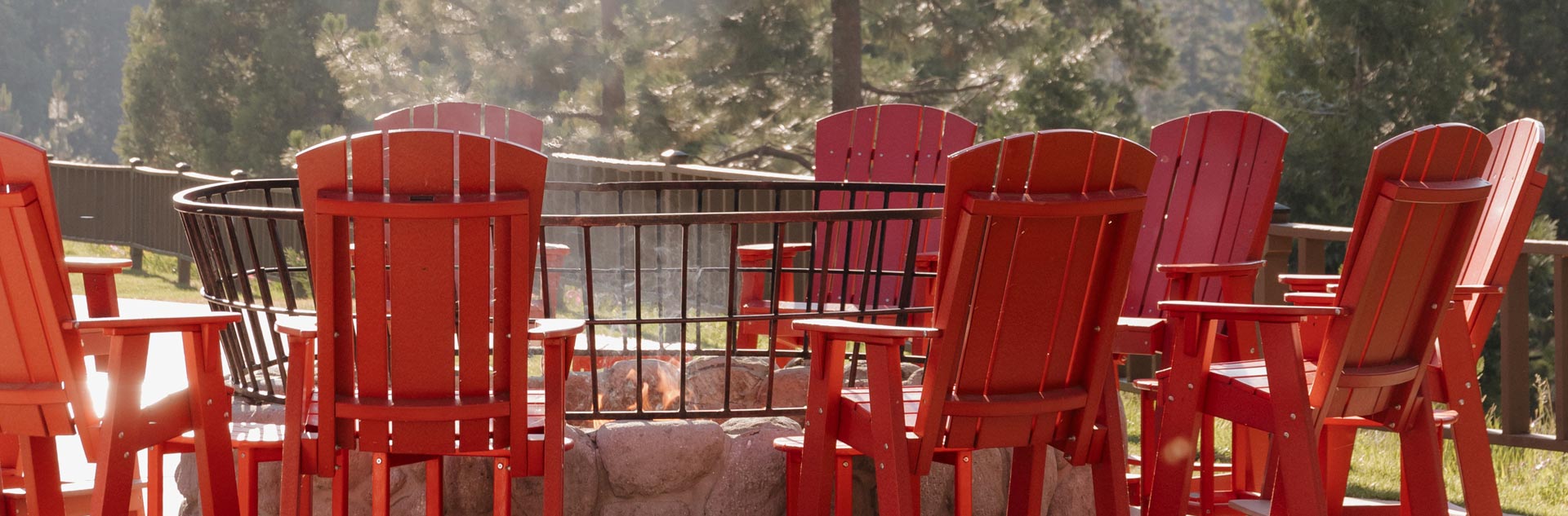 Adirondack chairs around an outdoor fire pit at Tenaya at Yosemite
